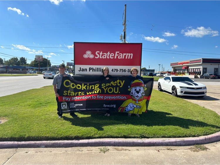 State Farm Insurance in front of sign with Fire Prevention Banner