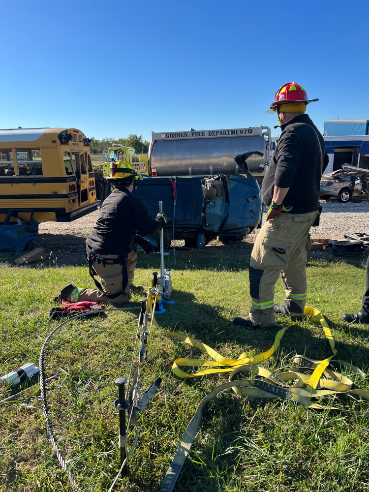 Crews Training removing a car from under a school bus